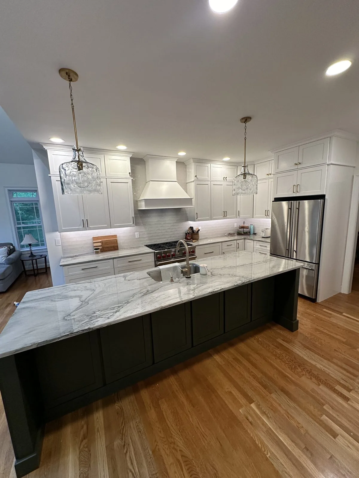 Remodeled kitchen with custom white cabinetry and marble island. Brook Road, Richmond, VA