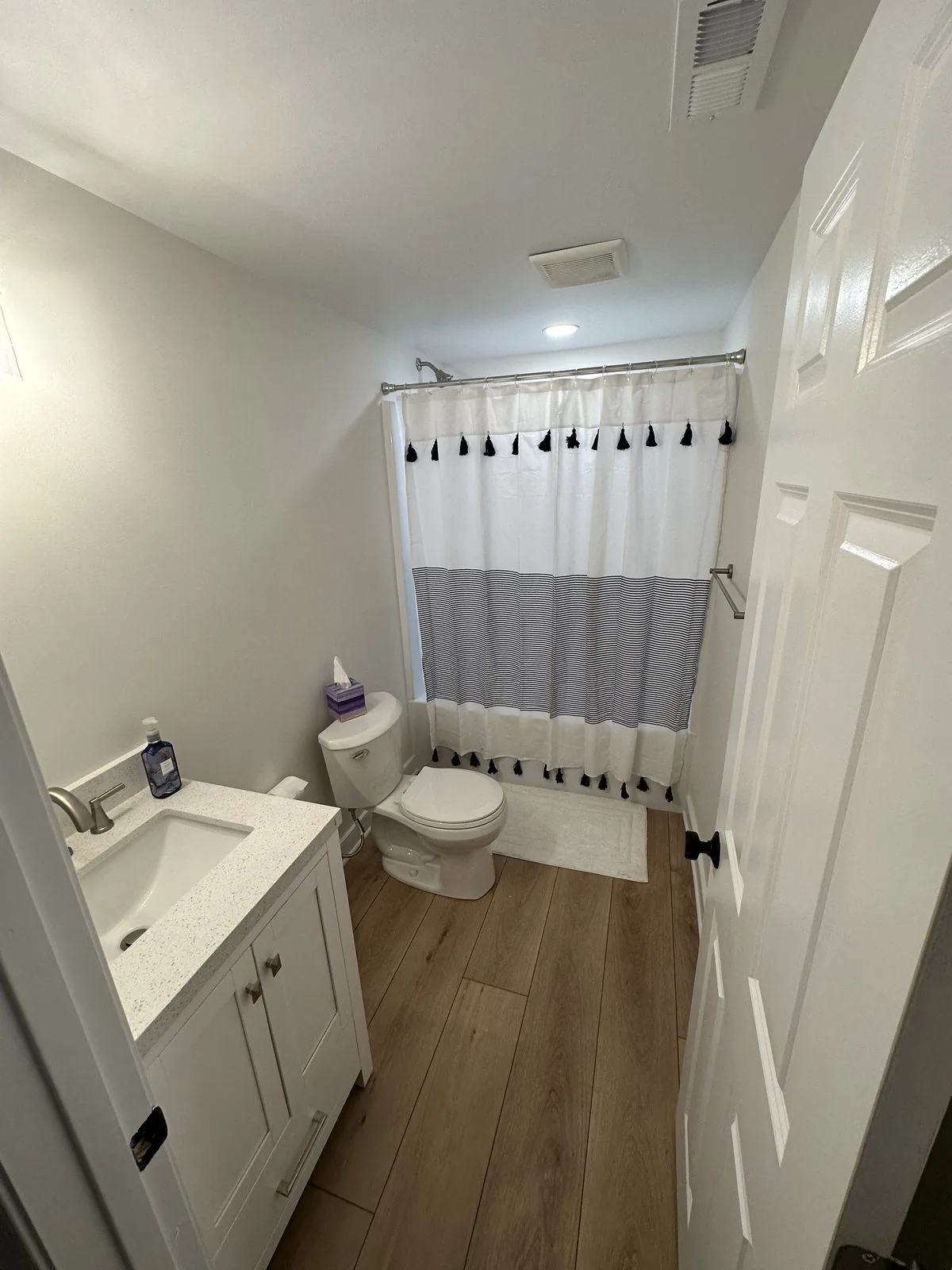 Finished basement bathroom with new vanity, tile, and flooring. Lake Summer Mews, Richmond, VA
