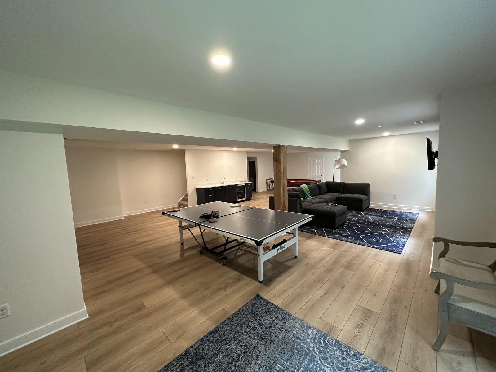 Finished basement with new flooring, lighting, and living space. Lake Summer Mews, Richmond, VA
